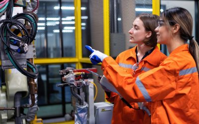 two women wear orange electrical safety dress and looking the electrcial supplies