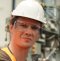 Fair-skinned man wearing a white safety helmet looking forward