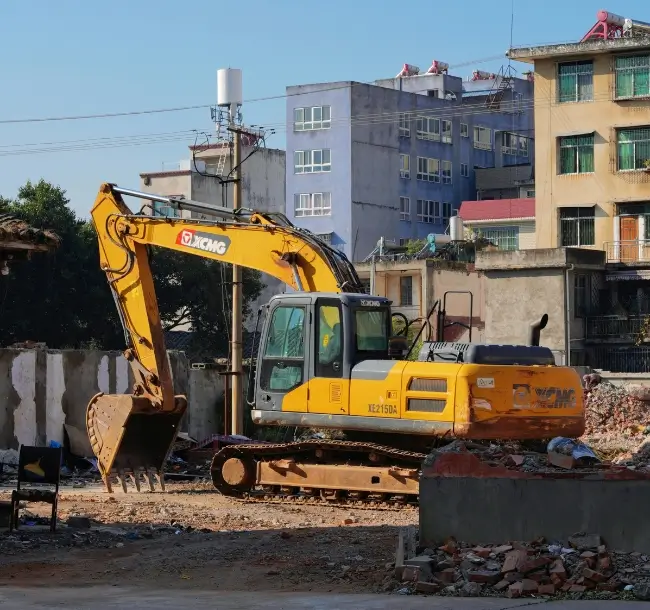 Yellow demolition crane working on a ground